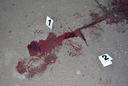 Red blood stain at the murder scene of a person - inspection of the crime scene.