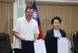 Infrastructure Development and Housing Minister, Julius Espat and Lily Li-Wen Hsu, Ambassador of the Republic of China (Taiwan), showing the agreement following the signing.