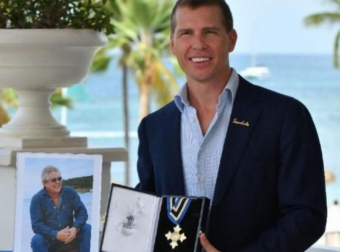 Adam Stewart, CD, Executive Chairman of Sandals Resorts International, accepting the Saint Lucia Cross Award on behalf of his late Father, Gordon 'Butch' Stewart.