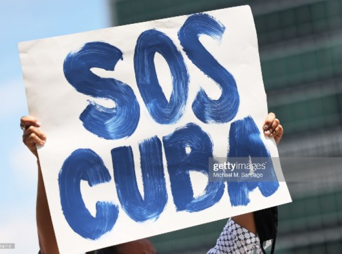 NEW YORK, NEW YORK - JULY 14: A person holds up a protest sign as people gather calling for help for Cuban protestors on the island in front of the United Nations on July 14, 2021in New York City. A small group of people gathered in front of the United Nations in support of the people of Cuba who have been protesting against the communist regime due to food shortage and worsening economic crisis that has been exasperated by the coronavirus (COVID-19) pandemic. The protest on the island has been the largest anti-government protest in decades. (Photo by Michael M. Santiago/Getty Images)