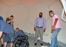 Minister of Home Affairs and Information, Wilfred Abrahams and MET Office Director, Sabu Best, watch as officials put the final touches on the installation of the new radar system. (Photo: BGIS)