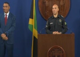 Police Commissioner Major General Antony Anderson at podium and watched by Prime Minister Andrew Holness (CMC Photo)