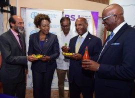 Minister of Industry, Investment and Commerce, Senator Aubyn Hill (second right), displays a hot pepper at the launch of the ‘Improving Phytosanitary, Food Safety and Market Access Opportunities along the Hot Pepper Value Chain in Jamaica’ project.