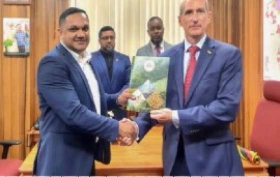 Minister of Natural Resources Vickram Bharrat presents ExxonMobil Guyana President Alistair Routledge with a Letter of Approval for the company’s 2023 Annual Local Content Plan. (ExxonMobil Guyana photo)
