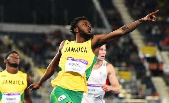 Jamaican Rasheed Broadbell celebrates at the finish of the men’s sprint hurdles on Thursday.