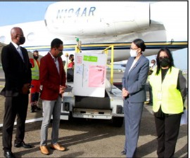 Trinidad and Tobago Foreign and CARICOM Affairs Minister, Dr. Amery Browne, (Second from left) and other officials accepting the shipment of vaccines from Bermuda at Piarco International Airport (Ministry of Foreign Affairs Photo)