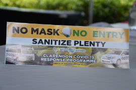 Bumper sticker handed out to taxi drivers in May Pen, Clarendon encouraging passengers to sanitize and wear mask prior to entering the vehicles.