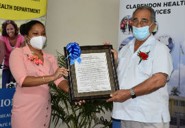 Custos Rotolorum of Clarendon, the Hon.William “Billy” Shagoury (Right), poses for a photo op after receiving a citation from Medical Officer 1 at the Clarendon Health Department Dr. Crystal Maragh at an appreciation ceremony held in his honour at the grounds of the Clarendon Health Department (CHD) on Monday, November 30, 2020.