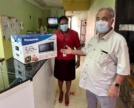 Custos William ‘Billy’ Shagoury donates a microwave to the May Pen Hospital in Clarendon. Customer Service Manager, Faith Sterling accepts the donation