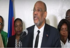 Prime Minister Dr. Ariel Henry, surrounding by Haitian officials, speaking at news conference (CMC photo)