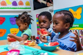 Jamaican children eating healthy fruit at school. UNICEF Jamaica/2019/Hakeem Hunter