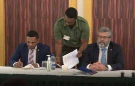 Minister of Natural Resources Vickram Bharrat (left) signing the agreement with Ambassador of the European Union to Guyana, Fernando Ponz Cantó.