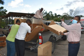 Southern Regional Health Authority (SRHA) Regional Director, Michael Bent (right), aids members of staff to pack equipment, including a generator, donated by the US Embassy for distribution to facilities within the region on Wednesday, November 18 2020 on the SRHA grounds. 