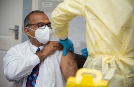 Minister of Health, Dr. Frank Anthony receives his COVID-19 vaccine (DPI Photo)