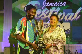2020 Jamaica Festival Song Winner, Buju Banton receives his winning trophy from the Hon. Olivia Grange, Minister of Culture, Gender, Entertainment and Sport at the Competition’s televised grand final last July.