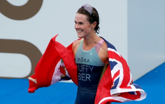 Bermudian Flora Duffy celebrates with the country’s flag after winning gold in Tokyo.