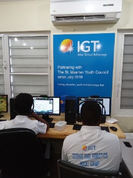 Students at St Maarten Youth Council Association, Rupert I. Maynard Youth Community Centre receive training in the virtual Coding and Robotics Rock! Camp held by International Game Technology (IGT) in collaboration with the Mona Geoinformatics Institute at UWI. The theme of the Camp, "Think it, Code it, Solve it," was designed to empower students as digital architects, enabling them to influence the future of the Caribbean through their exceptional abilities in critical thinking, innovation, and problem-solving.