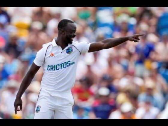 Kemar Roach (right) celebrates after removing England captain Joe Root to move to seventh on the West Indies all-time list of wicket-takers.