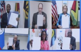 CARICOM Secretary general Irwin LaRocque (second from left) and delegates at USAID symposium