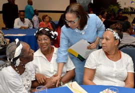 Labour and Social Security Minister, Hon. Shahine Robinson (2nd right), greets a member of the ‘Recycled Teenagers’ dance group of the National Council for Senior Citizens, Winsome Wedderburn, following the launch of Senior Citizens Week at the Jamaica Pegasus Hotel, New Kingston (September 21, 2018).PHOTO: DAVE REID