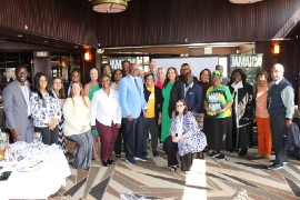 Minister of Tourism Hon. Edmund Bartlett center poses for a photograph with top travel agents from Baltimore and Philadelphia at a luncheon hosted by the Jamaica Tourist Board at McCormick & Schmick’s restaurant downtown Baltimore on Friday, April 12. (Photo by Derrick Scott)
