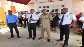 Prime Minister Phillip J Pierre (right) flanked by Customs and Police officials addressing employees of the Customs and Excise following the shooting