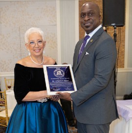 Lesleyann Samuel accepts her award from Rainford "Perry" Bloomfield, Immediate Past President of the KC Old Boys Association New York Chapter. (Photo courtesy of  Leonard McKenzie)