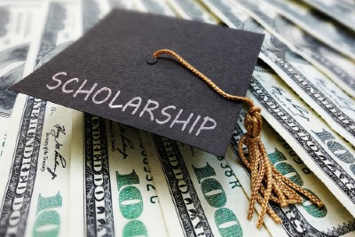 Scholarship graduation cap on money                