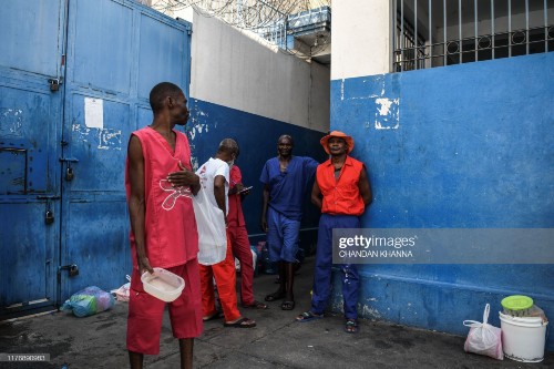 Prison inmates wait for food as they stand inside Haiti's National Penitentiary in Port-au-Prince, Haiti, on August 30, 2019. - The political crisis that has paralysed Haiti since late August has had extreme consequences for prisoners, the vast majority of whom have been waiting to be tried for months or even years. (Photo by CHANDAN KHANNA / AFP) (Photo by CHANDAN KHANNA/AFP via Getty Images)
