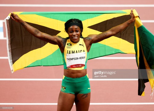 TOKYO, JAPAN - AUGUST 3: Elaine Thompson-Herah of Jamaica wins the Gold Medal during the Women's 200m Final on day eleven of the athletics events of the Tokyo 2020 Olympic Games at Olympic Stadium on August 3, 2021 in Tokyo, Japan. (Photo by Jean Catuffe/Getty Images)