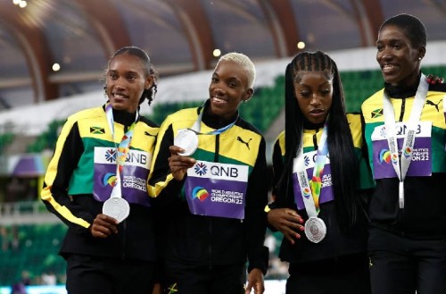 EUGENE, OREGON - JULY 24: Silver medalists Stephenie Ann McPherson, Candice McLeod, Charokee Young, and Janieve Russell of Team Jamaica, gold medalists Talitha Diggs, Abby Steiner, Britton Wilson and Sydney McLaughlin of Team United States and bronze medalists Laviai Nielsen, Nicole Yeargin, Victoria Ohuruogu, and Jessie Knight of Team Great Britain on day ten of the World Athletics Championships Oregon22 at Hayward Field on July 24, 2022 in Eugene, Oregon. (Photo by Steph Chambers/Getty Images)