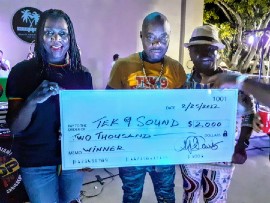 Miramar Commissioner Alexandra P. Davis (left) and West Park Commissioner Joy Smith (right) presents Tek 9 Sound with the winner takes all check after being victor of Di Clash - Rumble in Miramar last night. (February 25) at Shirley Branca Park.