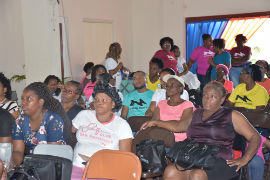 Members of the audience pay attention to a testimonial from a participant who spoke about her diagnosis of cancer and recovery.