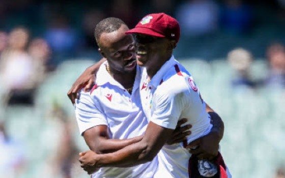 Kemar Roach (left) celebrates a wicket with Shamar Joseph during the opening Test in Adelaide.