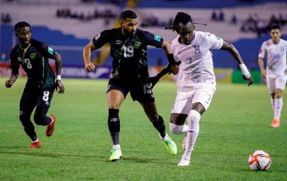 Adrian Mariappa (Left) of Jamaica and Alberth Elis of Honduras battle for possession during a Concacaf World Cup qualifier match at Estadio Olimpico, Honduras on October 13, 2021.
