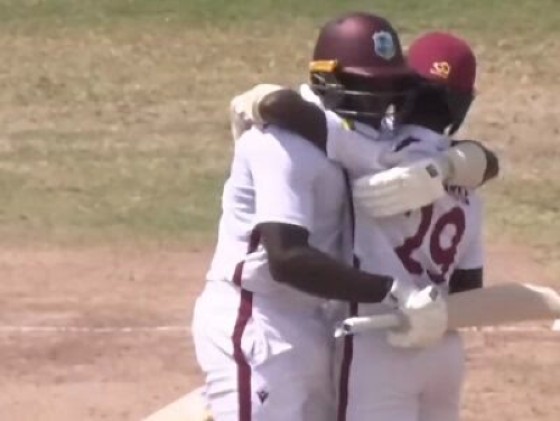 Amari Goodridge (left) congratulates Rivaldo Clarke after he scored his maiden first-class century against the Guyana Harpy Eagles.