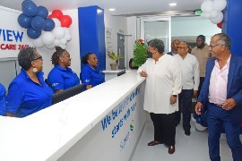 Prime Minister Mia Amor Mottley chats with staff of the newly opened Bayview Hospital’s Urgent Care facility during a tour, following the official opening. Looking on are Minister of Health and Wellness, Senator Dr Jerome Walcott, and Bayview Hospital Board Chairman, Peter Harris (right). (Photo: BGIS)