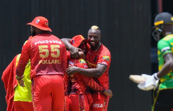 Andre Russell (right) celebrates with TKR teammates on Sunday. (Photo courtesy CPLT20/Getty Images)