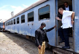 Minister of Transport and Mining Audley Shaw (center), disembarks a train during a recent tour of the Jamaica Railway Corporation (JRC) terminus in West Kingston.