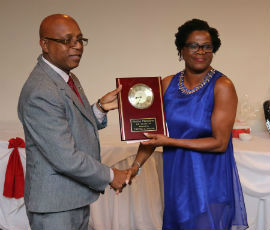 President of the Cedric Titus Old Students Association – Jamaica Chapter, Mr. Devon Brown, on behalf of former principal Elette M. Fletcher accepts a token of appreciation from Belver Williams-Niblett, for Mrs. Fletcher’s 34 years of service to Cedric Titus High School.The presentation took place at 10th Annual Valentine’s Day Gala of the North America Chapter of the Cedric Titus Old Student Association (CTOSA), on Saturday, February 15, 2020 at Venue 518 in Bound Broad, New Jersey.( Derrick Scott Photo)