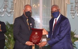 UWI Vice-Chancellor, Sir Hilary Beckles (left) receiving award from Governor General, Sir Rodney Williams (Photo Office of the Governor General)
