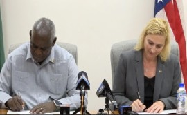 Home Affairs Minister Robeson Benn and United States Ambassador to Guyana, Nicole Theriot, sign security agreement on Monday .