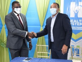 Health and Wellness Minister Dr. Christopher Tufton (Right) and CW Jamaica Limited vice president Stephen price at the signing ceremony. (Photo by Nicholas Nunes)
