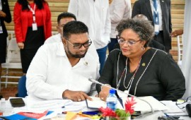 President Dr. Irfaan Ali and Prime Minister Mia Mottley confer during Tuesday’s session of the CARICOM Inter-Sessional Summit (Photo courtesy Prime Minister Mia Mottley’s Facebook page)