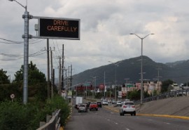 A sign urging motorists to be careful on the roads in Jamaica (PAHO photo)