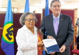 CARICOM Secretary General Dr. Carla Barnett and PAHO Director, Dr. Jarbas Barbosa show off the agreement signed on Tuesday.