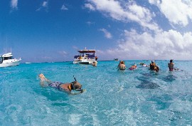 Tourists enjoy snorkeling activities in Grand Cayman, Cayman Islands. (Photo credit: © Philip Coblentz—Digital Vision/Getty Images)