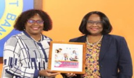 CDB Vice-President, Mrs. Yvette Lemonias Seale presents Barbados’ Education Minister Kay S. McConney with a token to commemorate the launch of the Lets Reap for Caribbean schools