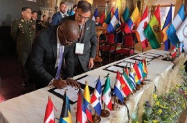 Foreign Affairs Minister, E.P Chet Greene signing the agreement at the 17th Conference of Defence Ministers held in Cusco, Peru.