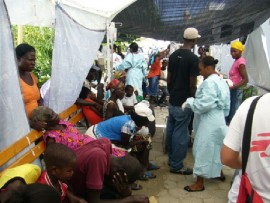 Haitian citizens wait to receive care by aid groups. The UN said in a recent statement that it's working with Haiti’s government to make sure that health teams are guaranteed safe access to areas where cases have been reported. (Photo courtesy of the CDC)